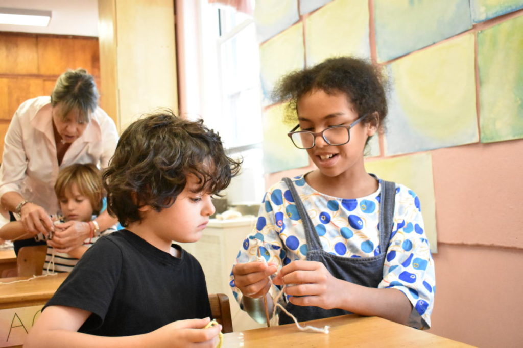 Every year the fifth grade students visit the first graders and teach them how to cast on and knit.